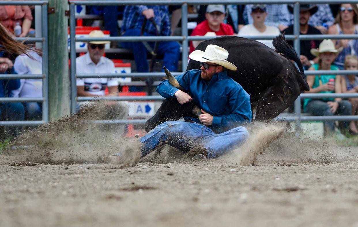 Ross Mosher competes in the steer wrestling event during the American Legion Pro Rodeo in Augusta on Sunday, June 27, 2021.
