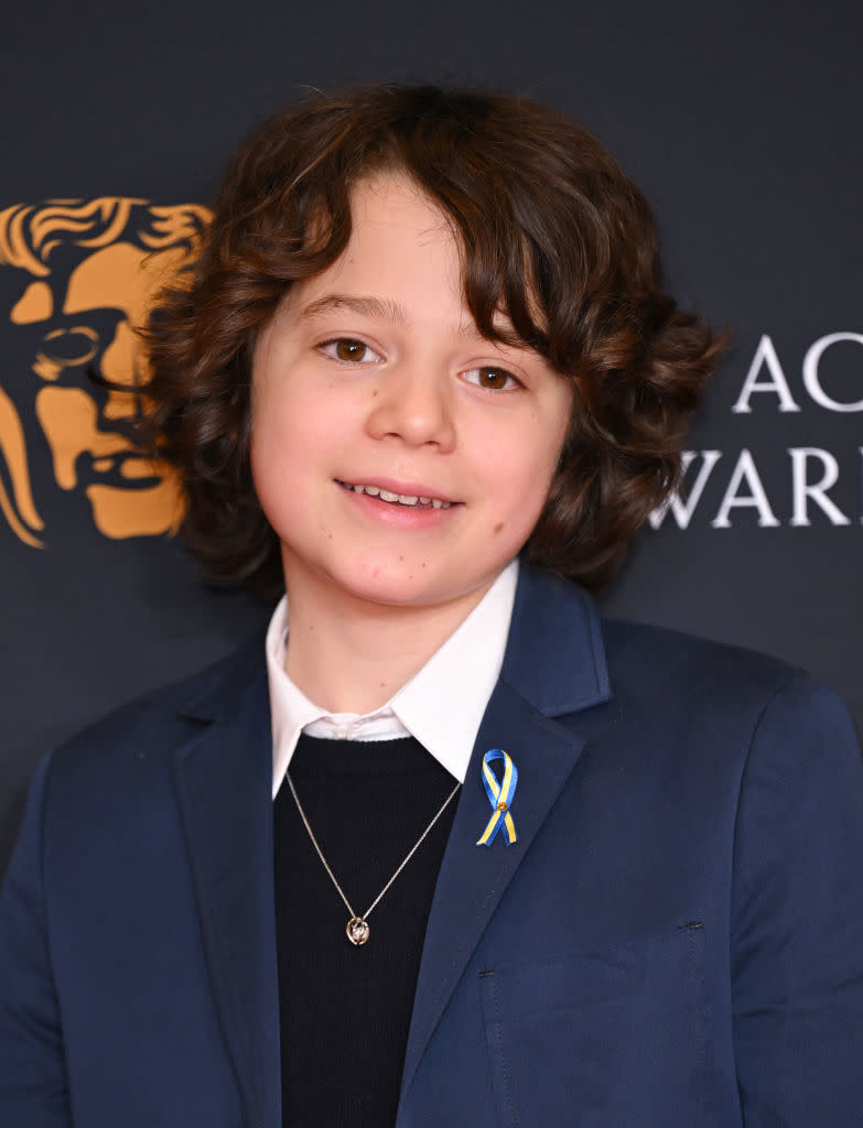 The British schoolboy was also wearing a ribbon to attend the Nominees' Reception at BAFTA on March 12. (Getty Images)