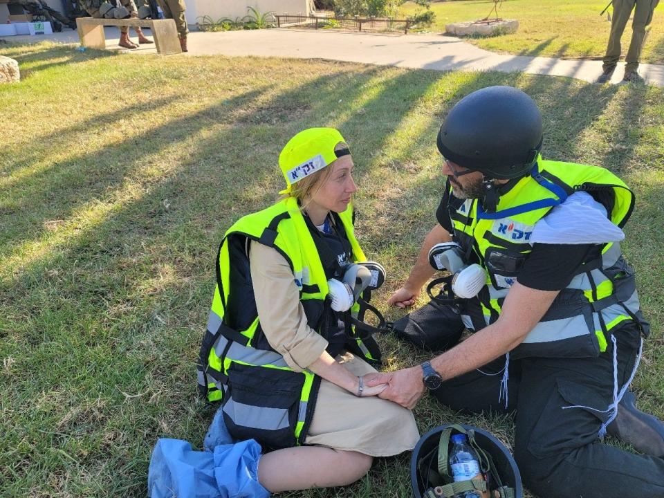 Valerie Dyksztejn is comforted by another ZAKA volunteer.