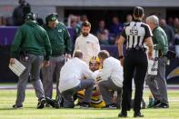 FILE PHOTO: Green Bay Packers quarterback Aaron Rodgers (12) is tended to after a hit by Minnesota Vikings linebacker Anthony Barr (55) (not pictured) in the first quarter at U.S. Bank Stadium, October 15, 2017; Minneapolis, MN, USA. Mandatory Credit: Brad Rempel-USA TODAY Sports