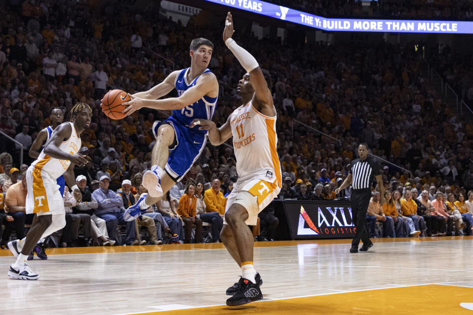 Kentucky guard Reed Sheppard (15) looks to pass the ball as he is defended by Tennessee forward Tobe Awaka (11) during the second half of an NCAA college basketball game Saturday, March 9, 2024, in Knoxville, Tenn. (AP Photo/Wade Payne)