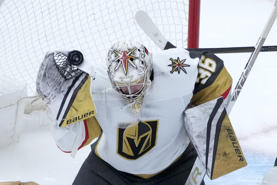 Vegas Golden Knights goaltender Logan Thompson deflects a shot above the net with his glove during the third period of an NHL hockey game against the Chicago Blackhawks Thursday, Dec. 15, 2022, in Chicago. The Golden Knights won 4-1. (AP Photo/Charles Rex Arbogast)