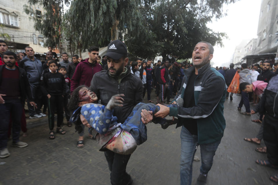 Palestinians evacuate survivors of the Israeli bombardment of the Gaza Strip in Rafah on Tuesday, Dec. 12, 2023. (AP Photo/Hatem Ali)