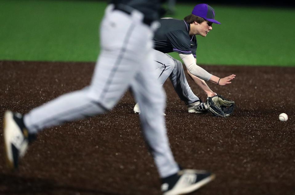 North Kitsap's Zach Edwards scoops up a ground ball against Central Kitsap in Silverdale on Friday, March 25, 2022.