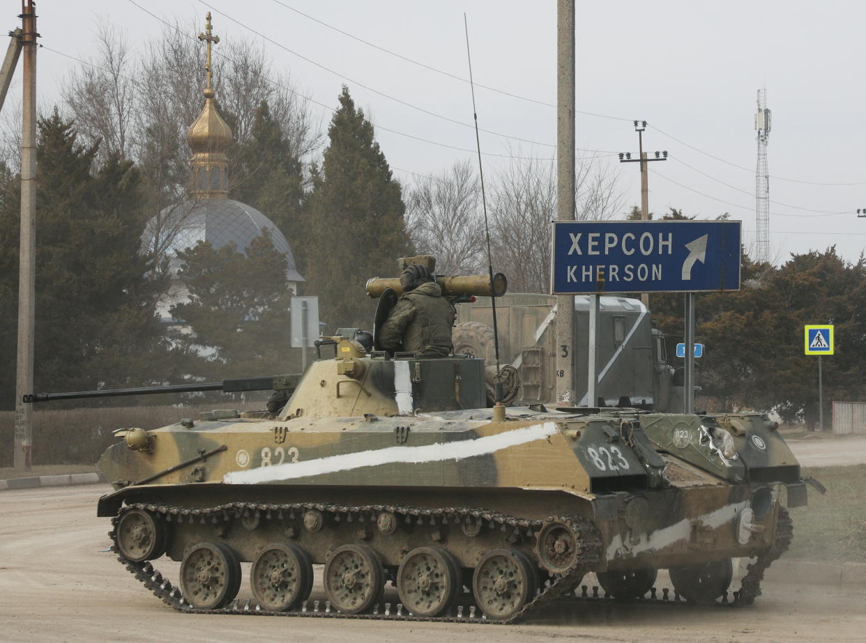 An armoured vehicle drives along a street, after Russian President Vladimir Putin authorized a military operation in eastern Ukraine, in the town of Armyansk, Crimea, February 24, 2022. REUTERS/Stringer