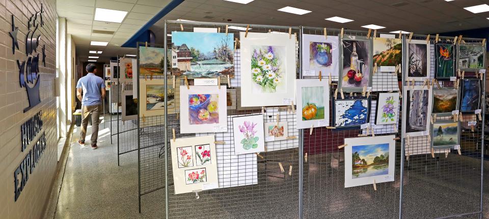 Hudsonites shop around the works of local artists during the Hudson Society of Artists Clothesline Show Saturday.