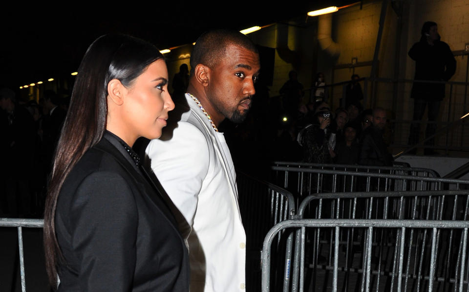 Kim Kardashian and Kanye West arrive at Givenchy's Ready to Wear's Fall-Winter 2013-2014 fashion collection presented Sunday, March 3, 2013 in Paris. (AP Photo/Zacharie Scheurer)