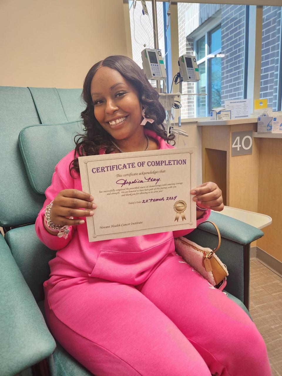 Angelica May poses with her certificate for completing chemotherapy during her bell ringing ceremony at Zimmer Cancer Institute in Wilmington on March 20, 2024.