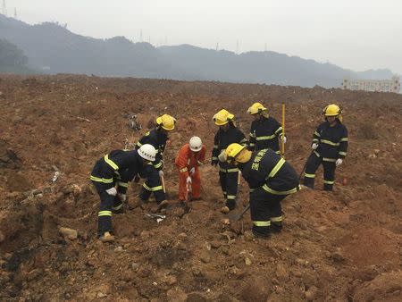 Rescuers search for survivors at the site of a landslide at an industrial park in Shenzhen, Guangdong province, China, December 20, 2015. REUTERS/Stringer