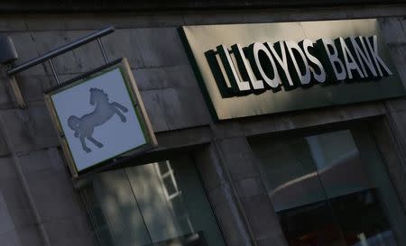 Signs are seen outside a branch of Lloyds Bank in central London October 28, 2014. REUTERS/Andrew Winning (BRITAIN - Tags: BUSINESS)