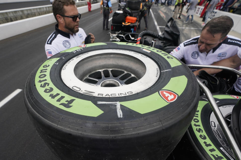 FILE - Tires made from natural rubber derived from a desert shrub, sit on a cart before the pit stop contest ahead of the Indianapolis 500 auto race at Indianapolis Motor Speedway, Friday, May 27, 2022, in Indianapolis. Bridgestone Americas said Thursday, Feb. 23, 2023, it has used the offseason to incorporate more sustainable and bio-circular materials into its tires this season, which has made it possible for Firestone to provide tires made with rubber derived from the guayule desert shrub at all five street circuits of the 17-race IndyCar season. (AP Photo/Darron Cummings, File)