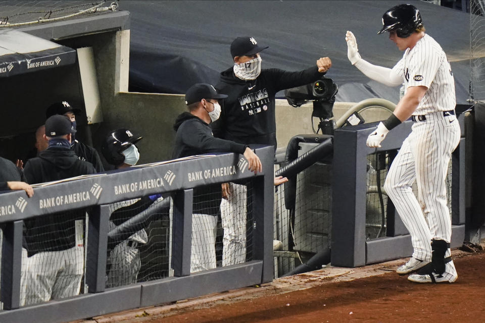 New York Yankees' Luke Voit, right, celebrates with teammates after hitting a home run during the fourth inning of a baseball game against the Toronto Blue Jays Thursday, Sept. 17, 2020, in New York. (AP Photo/Frank Franklin II)