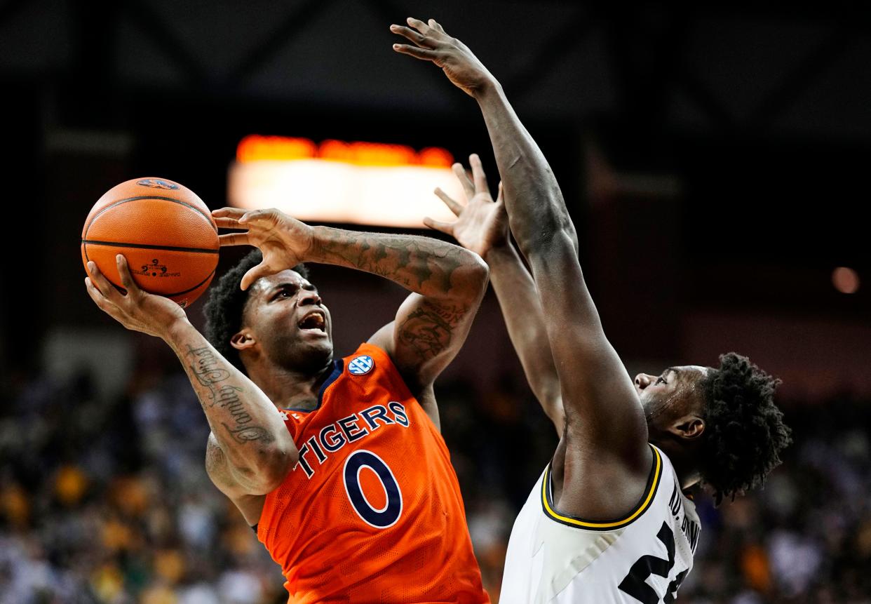 Auburn guard K.D. Johnson (0) goes up for a shot against Missouri forward Kobe Brown (24) during a game Tuesday night at Mizzou Arena.