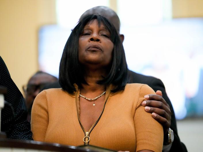Tyre Nichols' mom RowVaughn Wells closes her eyes in grief as Ben Crump puts a hand on her shoulder in comfort