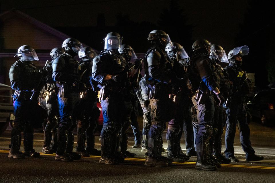 Portland police take control of the streets after making arrests on the scene of the nightly protests at a Portland police precinct on Sunday, Aug. 30, 2020 in Portland, Ore. Oregon State Police will return to Portland to help local authorities after the fatal shooting of a man following clashes between President Donald Trump supporters and counter-protesters that led to an argument between the president and the city's mayor over who was to blame for the violence.(AP Photo/Paula Bronstein) ORG XMIT: ORPB209