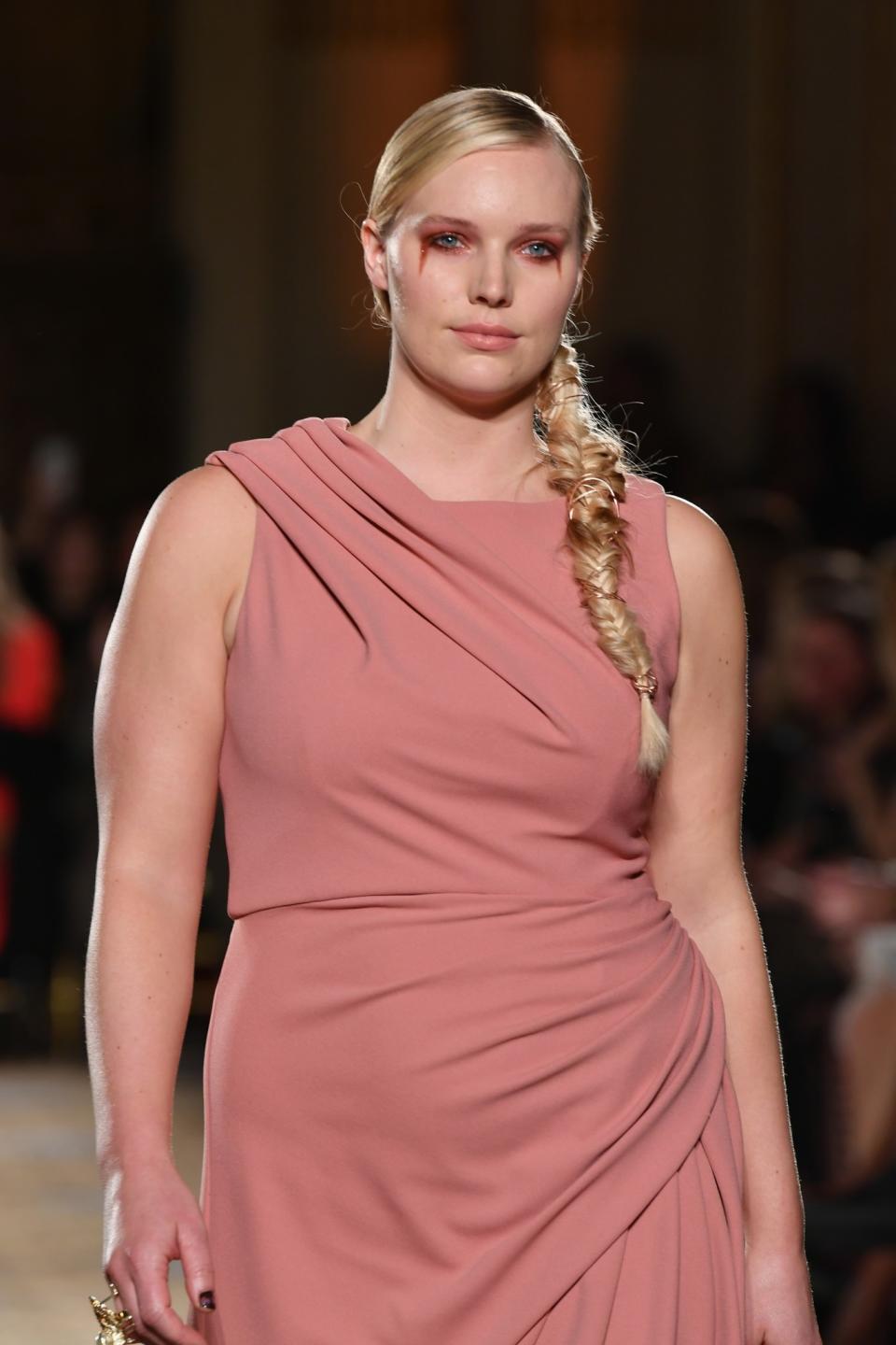 This blond beauty effortlessly pulls off this soft pale pink gown at Christian Siriano.