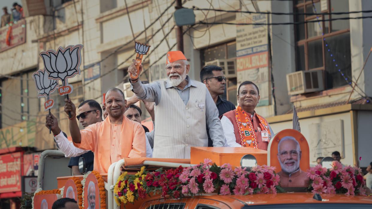  Prime Minister Narendra Modi greets supporters at a roadshow on April 06, 2024 in Ghaziabad, Uttar Pradesh, India. 