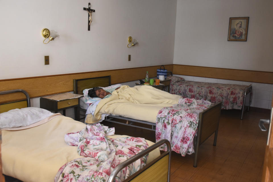 An elderly woman infected with COVID-19 rests in an isolated area of the San Jose nursing home in Cochabamba, Bolivia, Friday, July 17, 2020. At least 60 residents at the senior care facility tested positive for the new coronavirus and 10 have died from related symptoms in the last two weeks, amid a rise in cases and fatalities in the Andean country. (AP Photo/Dico Solis)