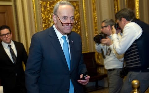 Sen. Charles Schumer walks to the chamber after a closed meeting with fellow democrats on Capitol Hill - Credit: AP