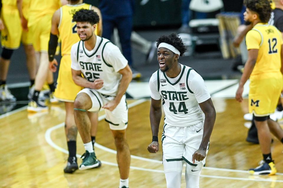 Michigan State's Gabe Brown, right, and Malik Hall celebrate after beating Michigan 70-64 on Sunday, March 7, 2021, at the Breslin Center in East Lansing.