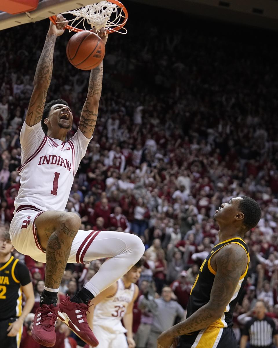 Indiana's Kel'el Ware (1) yells as he dunks against Iowa's Tony Perkins (11) during the second half of an NCAA college basketball game, Tuesday, Jan. 30, 2024, in Bloomington, Ind. (AP Photo/Darron Cummings)