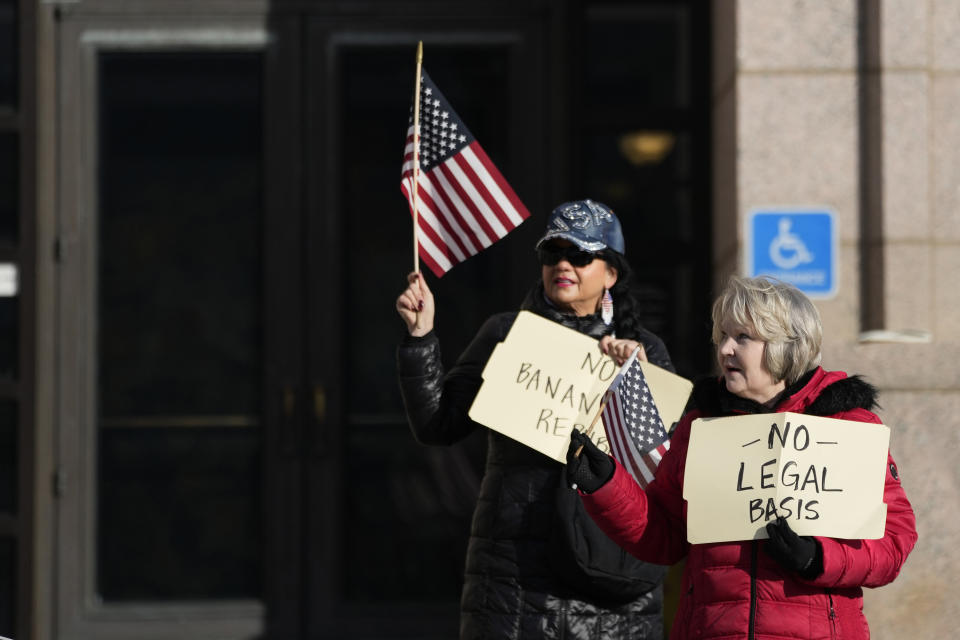 Trump supporters hold signs outside the Minnesota Judicial Center, Thursday, Nov. 2, 2023, in St. Paul, Minn. Efforts to use the Constitution's "insurrection" clause to prevent former President Donald Trump from running again for the White House turn to Minnesota on Thursday with oral arguments before the state Supreme Court, a hearing that will unfold as a similar case plays out in Colorado. (AP Photo/Abbie Parr)