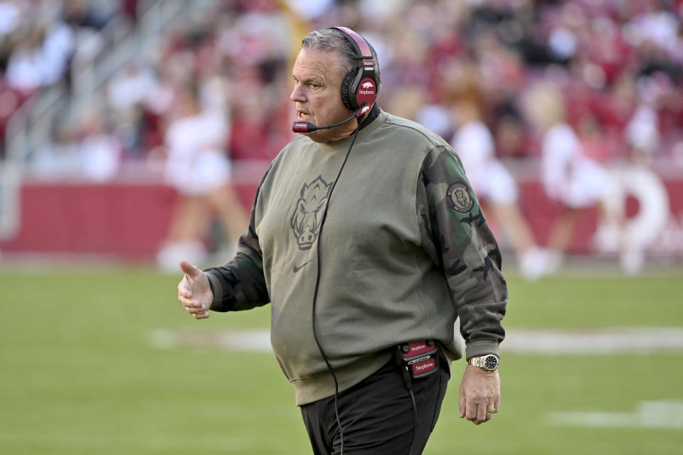 Arkansas coach Sam Pittman talks with players on the sideline during an NCAA college football game against Auburn, Saturday, Nov. 11, 2023, in Fayetteville, Ark. (AP Photo/Michael Woods)