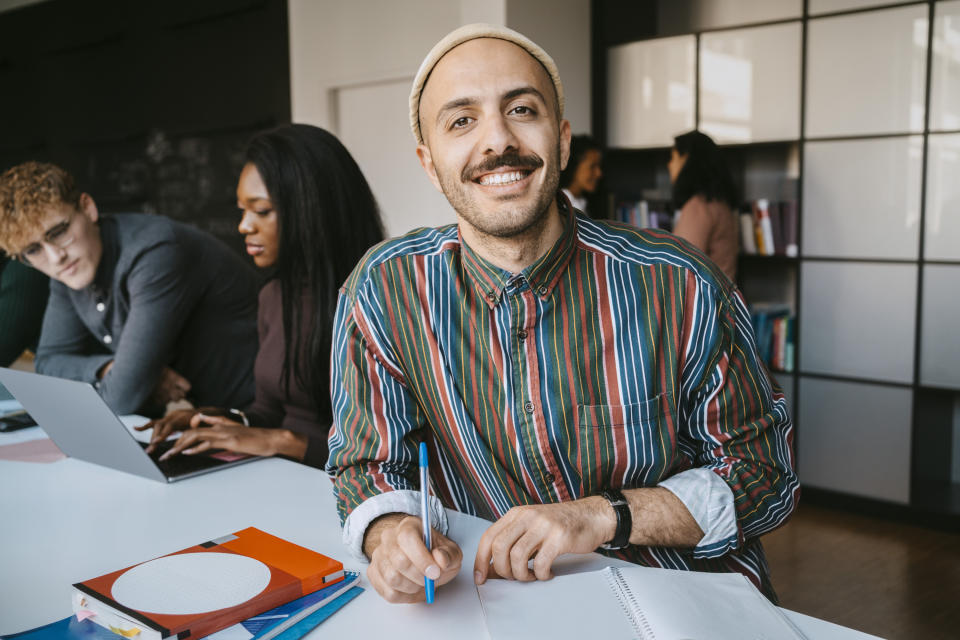 Man in college smiling at the camera