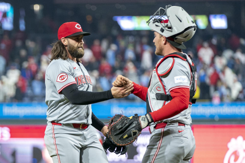 Cincinnati Reds relief pitcher Tejay Antone, left, celebrates the win with catcher Luke Maile, right, following a baseball game against the Philadelphia Phillies, Monday, April 1, 2024, in Philadelphia. (AP Photo/Chris Szagola)