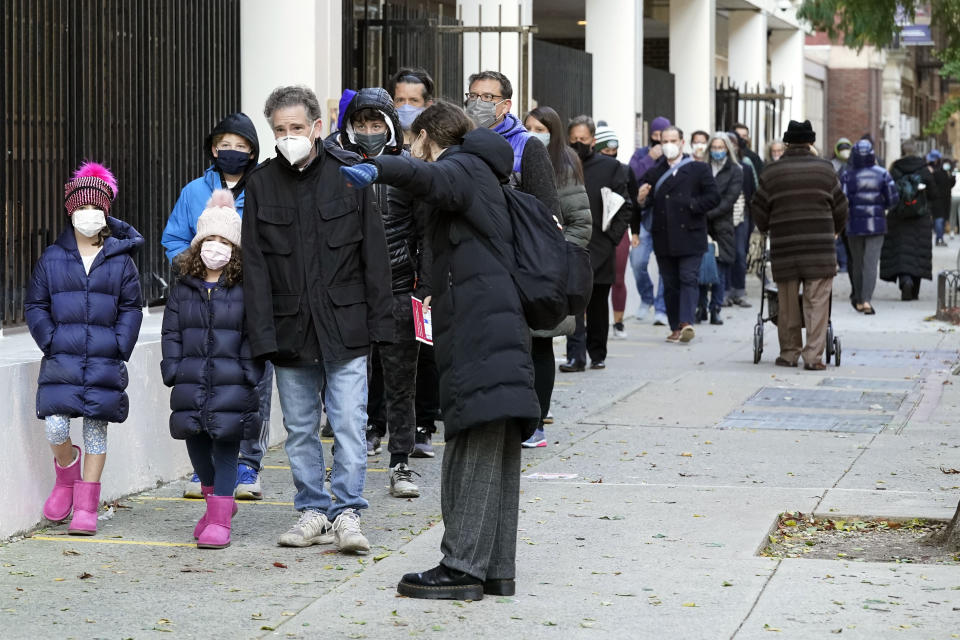 Voters line up outside Frank McCourt High School on Election Day, on New York's Upper West Side, Tuesday, Nov. 3, 2020. (AP Photo/Richard Drew)