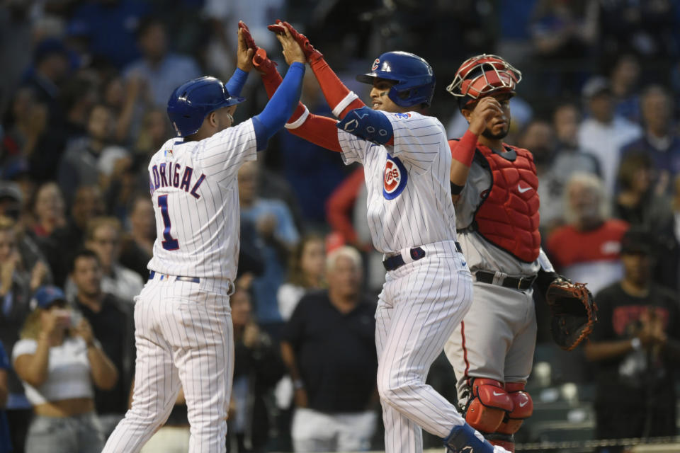 Chicago Cubs' Christopher Morel, center, celebrates with teammate Nick Madrigal (1) at home plate after hitting a two-run home run while Washington Nationals catcher Keibert Ruiz, right, looks on during the third inning of baseball game Monday, Aug. 8, 2022, in Chicago. (AP Photo/Paul Beaty)