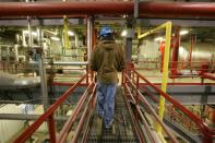 Logistics supervisor Travis Harrison walks among pipes and machinery that convert corn into ethanol inside the Lincolnway Energy plant in the town of Nevada, Iowa in this December 6, 2007 file photo. REUTERS/Jason Reed/Files