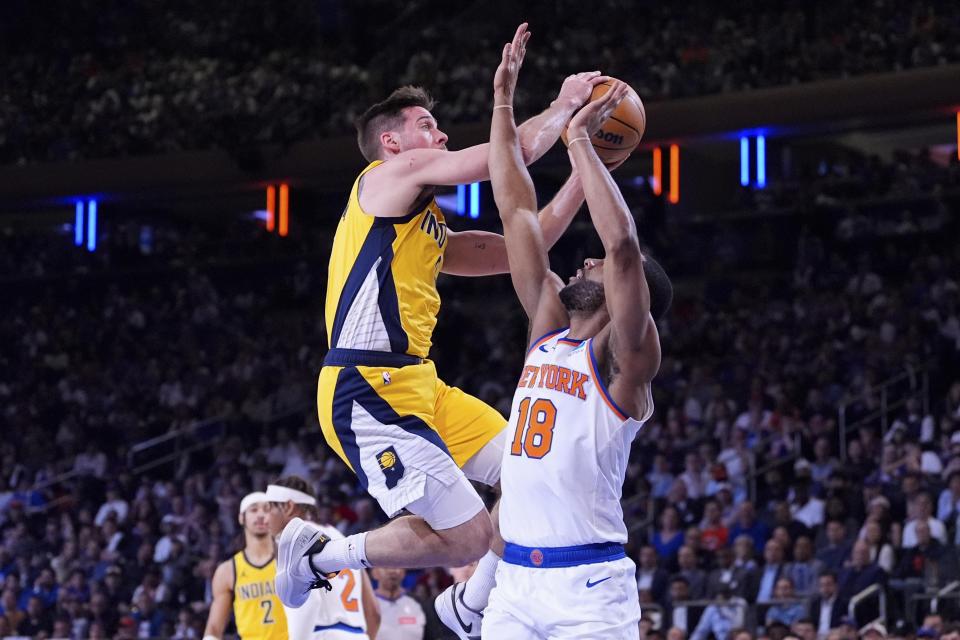 Indiana Pacers guard T.J. McConnell shoots past New York Knicks guard Alec Burks during the first half of Game 7 in an NBA basketball second-round playoff series, Sunday, May 19, 2024, in New York. (AP Photo/Julia Nikhinson)