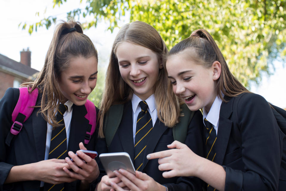 School girls with mobile phones. (Getty Images)