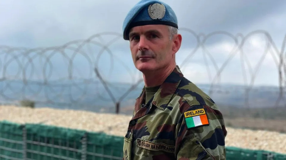 Lieutenant Colonel Cathal Keohane facing the camera with barbed wire behind him