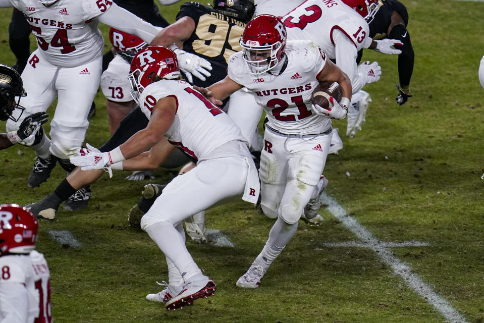 Rutgers quarterback Johnny Langan (21) runs against Purdue during the fourth quarter of an NCAA college football game in West Lafayette, Ind., Saturday, Nov. 28, 2020. (AP Photo/Michael Conroy)