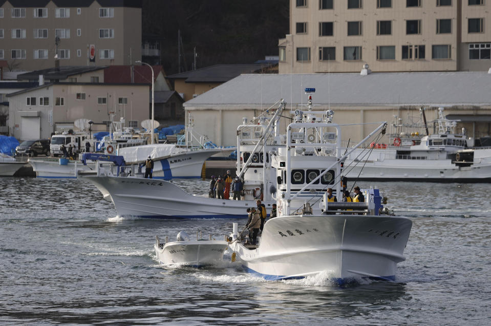 Fishing boats leave a port to search for a missing tour boat in Shari, in the northern island of Hokkaido Sunday, April 24, 2022. The Japanese Coast Guard said Sunday that their helicopters found four of the 26 people on a tour boat missing since the day before. (Kyodo News via AP)