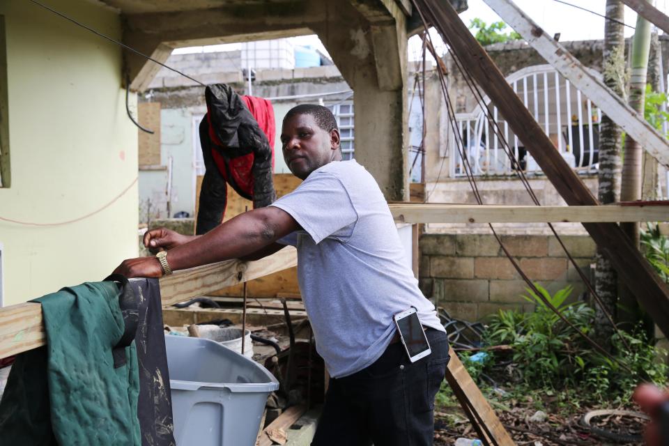 After sorting through his damaged belongings, Juan Medina-Dishmey rests on his front porch three weeks after the storm.&nbsp; (Photo: Carolina Moreno/HuffPost)