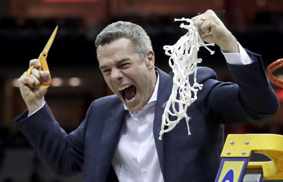 Virginia head coach Tony Bennett celebrates after defeating Purdue 80-75 in overtime of the men's NCAA Tournament college basketball South Regional final game, Saturday, March 30, 2019, in Louisville, Ky. (AP Photo/Michael Conroy)