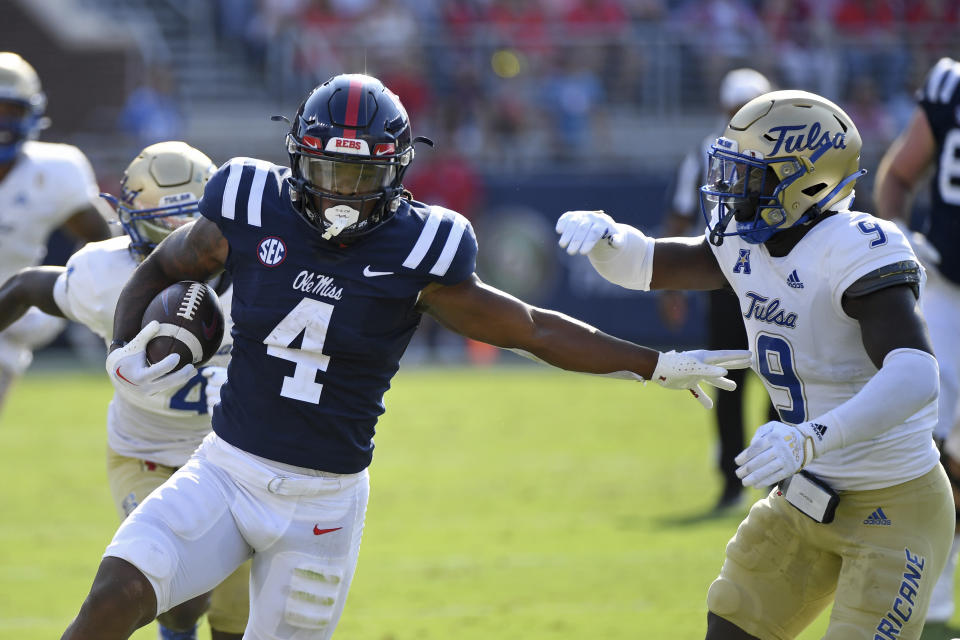 Mississippi running back Quinshon Judkins (4) runs the ball past Tulsa safety Daiquain Jackson (9) during the first half of an NCAA college football game in Oxford, Miss., Saturday, Sept. 24, 2022. (AP Photo/Thomas Graning)