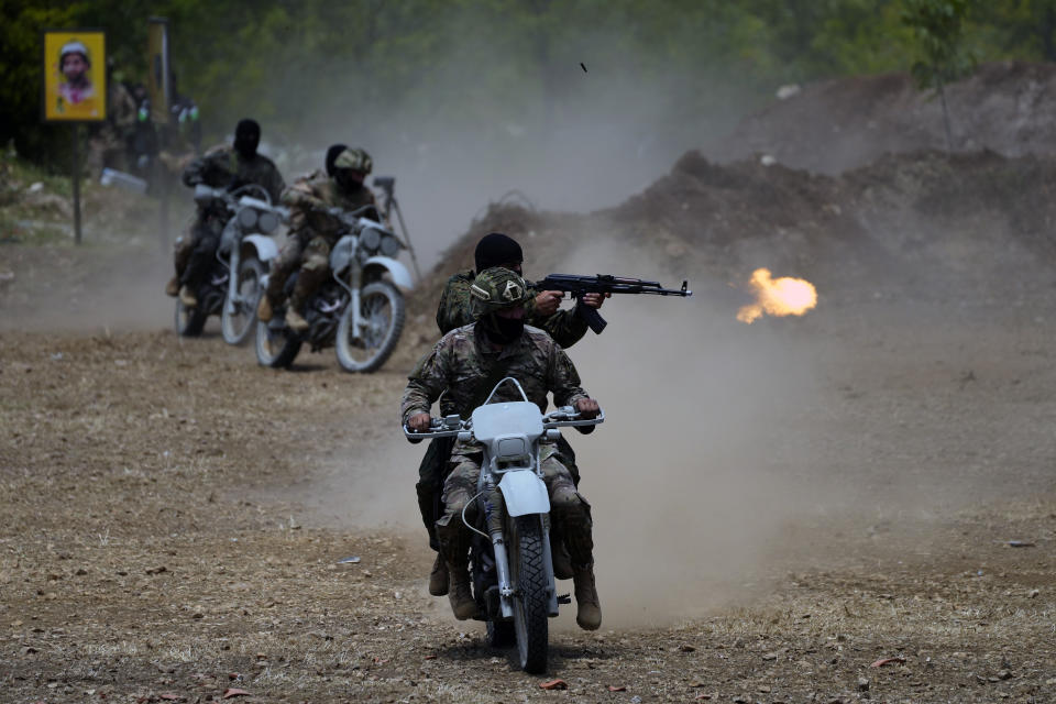 FILE - Fighters from the Lebanese militant group Hezbollah carry out a training exercise in Aaramta village in the Jezzine District, southern Lebanon, Sunday, May 21, 2023. Thousands of fighters from Iran-backed groups in the Middle East are offering to come to Lebanon to join the militant Hezbollah group in its fight with Israel. (AP Photo/Hassan Ammar, File)