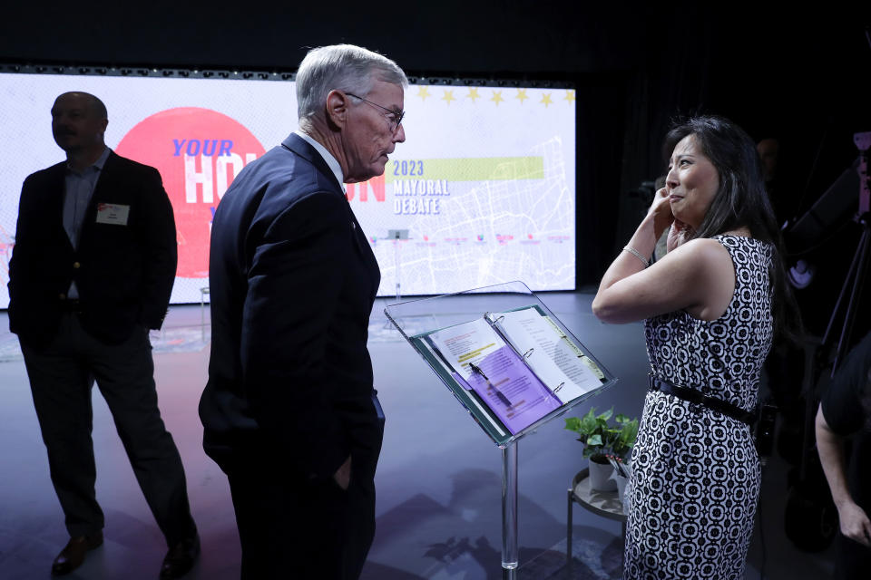 Houston mayoral candidate Jack Christie, center, talks with debate moderator Christina Yao Lee, right, before the start of a candidates debate held at the Houston Public Media studios Thursday, Oct. 19, 2023, in Houston. (AP Photo/Michael Wyke)