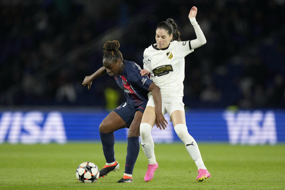 PSG's Sandy Baltimore shields the ball from Hacken's Clarissa Larisey, right, during the women's Champions League quarterfinals, second leg, soccer match between Paris Saint-Germain and BK Hacken at Parc des Princes, in Paris, Thursday, March 28, 2024. (AP Photo/Thibault Camus)