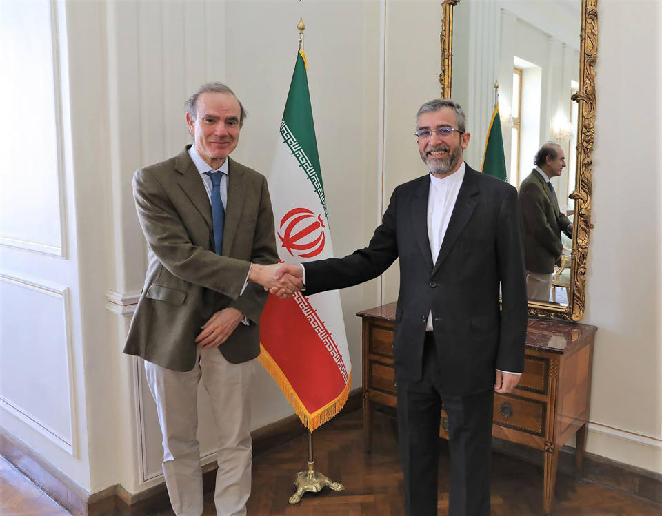 In this photo released by the Iranian Foreign Ministry, Enrique Mora, a leading European Union diplomat, left, shakes hands with Iran's top nuclear negotiator Ali Bagheri Kani in Tehran, Iran, Sunday, March 27, 2022. Mora held talks in Tehran amid hopes that an agreement to restore Iran's tattered nuclear deal with world powers could be completed. (Iranian Foreign Ministry via AP)