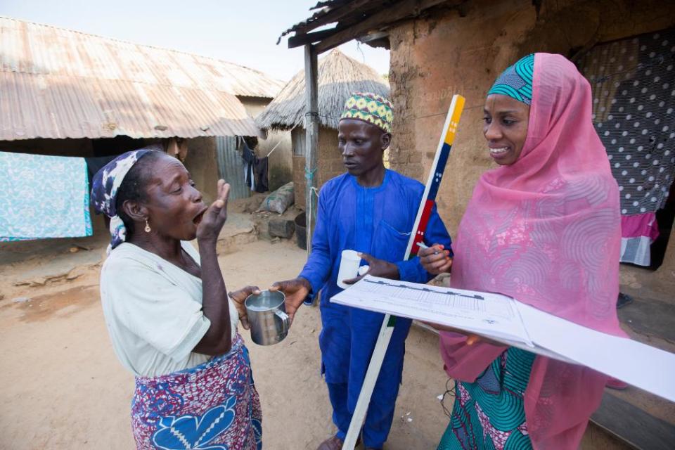 Local workers administer treatment to prevent river blindness in Nigeria, which affects about one in five people across the globe