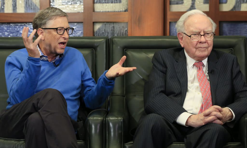 Berkshire Hathaway Chairman and CEO Warren Buffett, right, and Bill Gates, Microsoft co-founder and director at Berkshire Hathaway, sit together