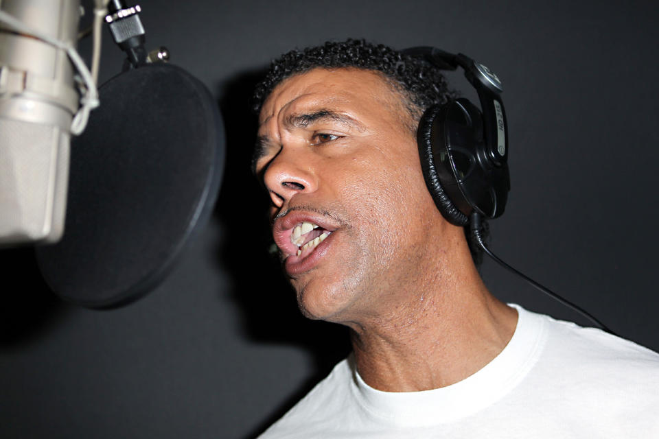 TV pundit Chris Kamara sings Sing 4 England, the official England song for Euro 2012, at a recording studio in central London. The song has the backing of the Football Association with all proceeds going to Marie Curie Cancer Care.   (Photo by Sean Dempsey/PA Images via Getty Images)