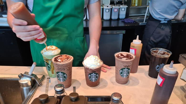 starbucks barista preparing various drinks