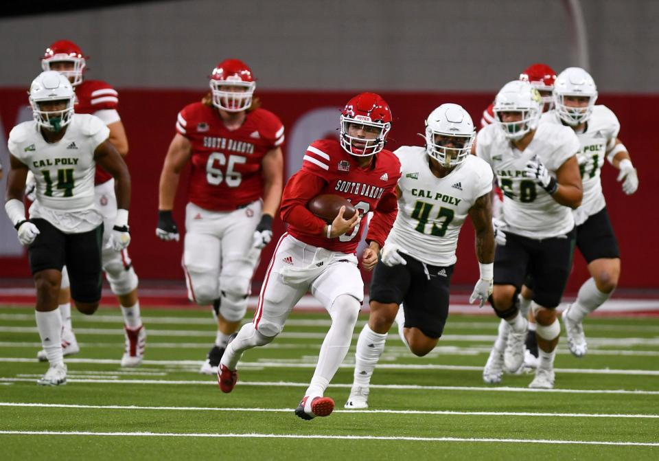 South Dakota’s Carson Camp carries the ball in a football game against Cal Poly on Saturday, September 17, 2022, at the DakotaDome in Vermillion. 