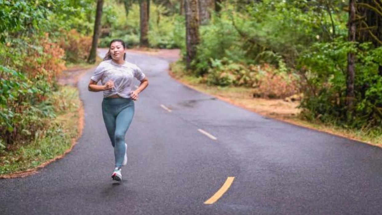  Woman running in Altra zero-drop shoes. 